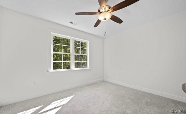 carpeted empty room featuring ceiling fan