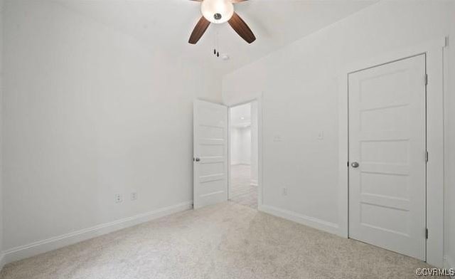 unfurnished bedroom featuring light colored carpet and ceiling fan