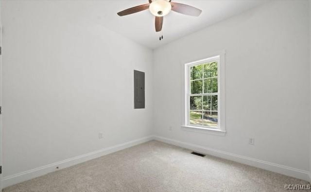 carpeted spare room with electric panel and ceiling fan