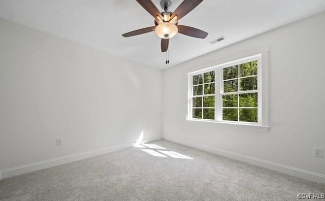 carpeted spare room with ceiling fan