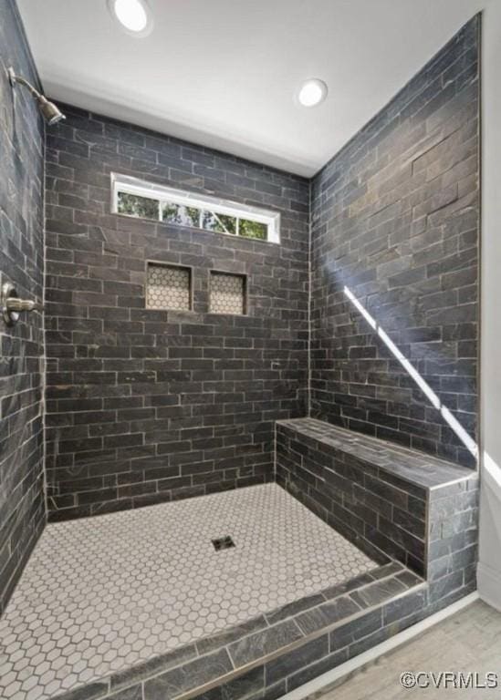 bathroom with a tile shower