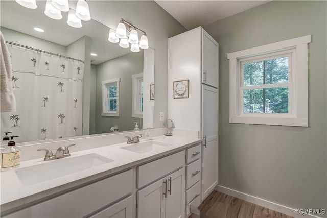 bathroom featuring a shower with shower curtain, vanity, and hardwood / wood-style flooring