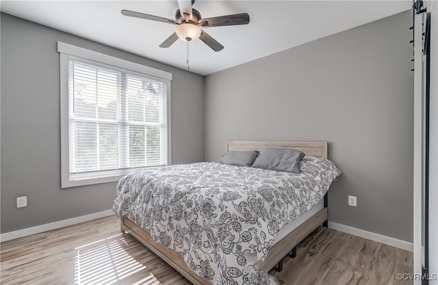 bedroom featuring light hardwood / wood-style floors and ceiling fan