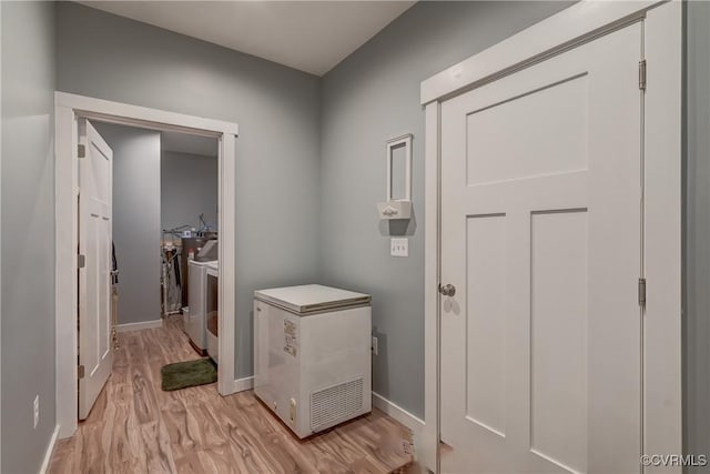 interior space with light hardwood / wood-style flooring and washer / dryer