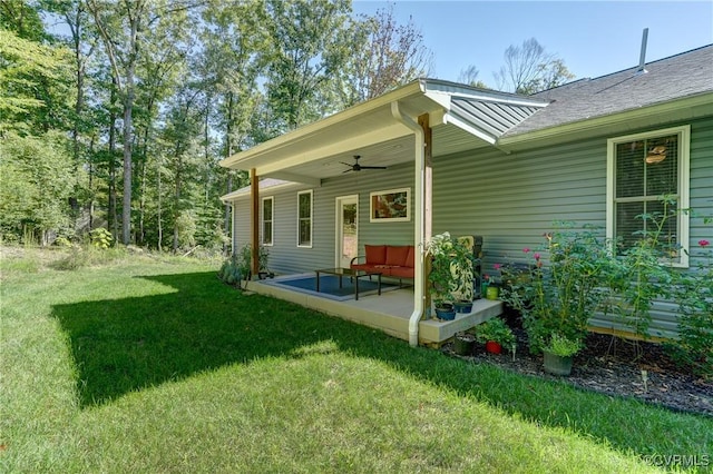 back of house featuring ceiling fan, a yard, and a patio