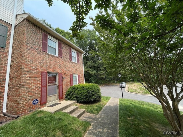 view of side of property with a yard