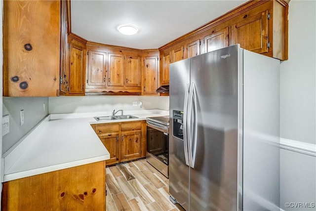 kitchen featuring sink, light hardwood / wood-style floors, and stainless steel appliances