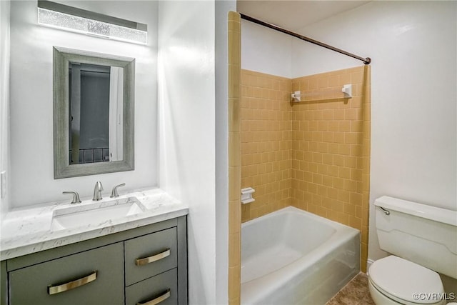 full bathroom with toilet, vanity, and tiled shower / bath