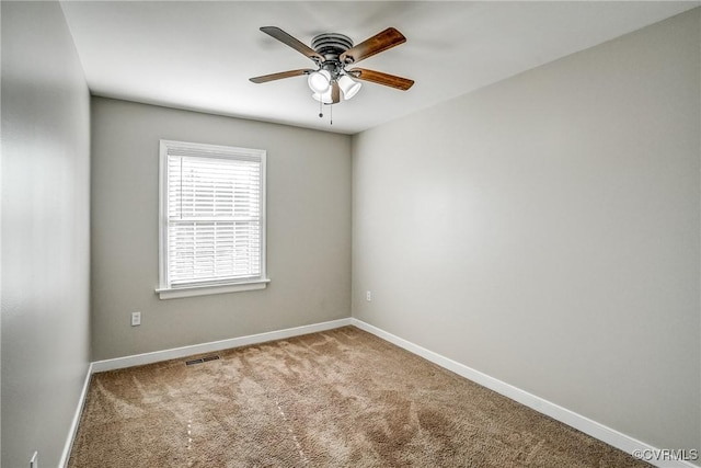 carpeted spare room with ceiling fan