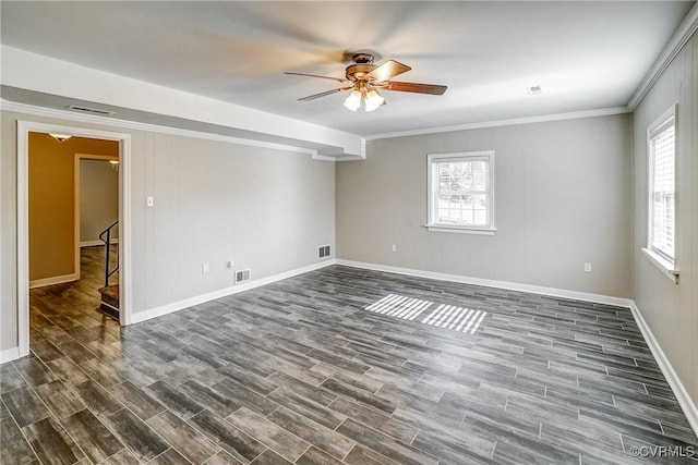 spare room featuring ceiling fan, dark wood-type flooring, and ornamental molding