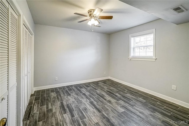 unfurnished bedroom featuring ceiling fan and dark wood-type flooring