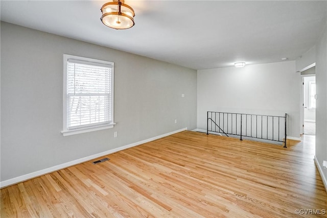 spare room with hardwood / wood-style flooring