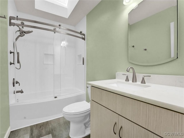 full bathroom featuring hardwood / wood-style floors, vanity,  shower combination, and toilet