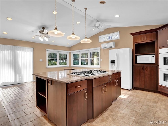 kitchen featuring a wall mounted air conditioner, white appliances, a center island, and lofted ceiling