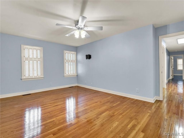 empty room featuring ceiling fan and hardwood / wood-style flooring