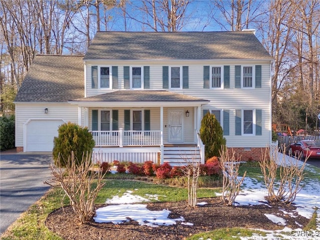 colonial house with a porch and a garage