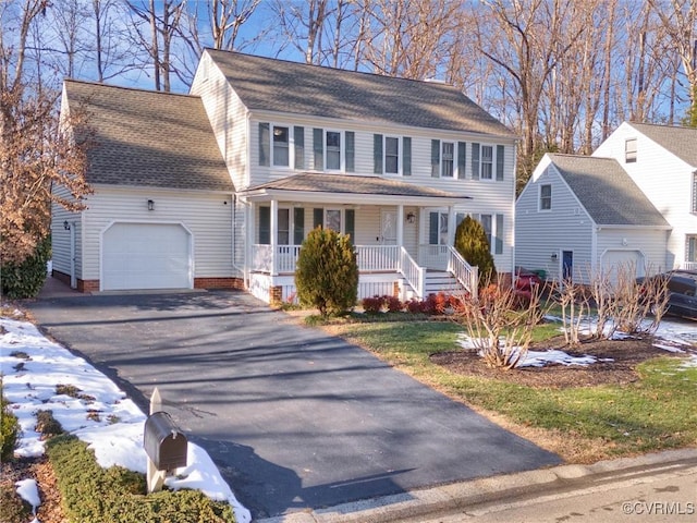 view of front of home featuring covered porch and a garage