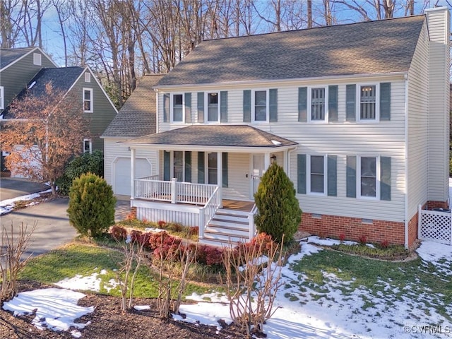 view of front of property with covered porch and a garage