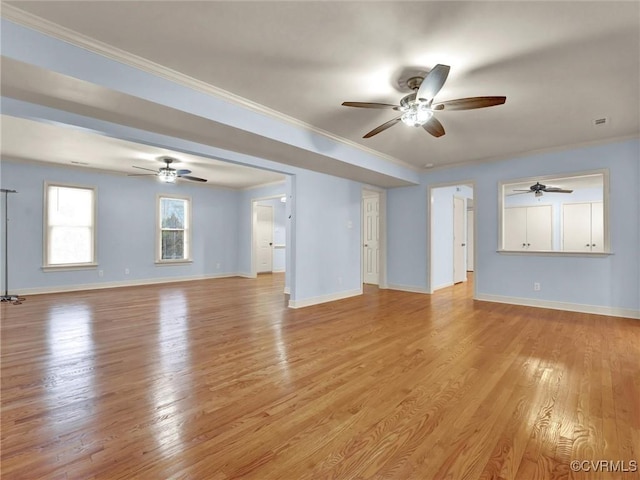 unfurnished living room with light wood-type flooring and ornamental molding