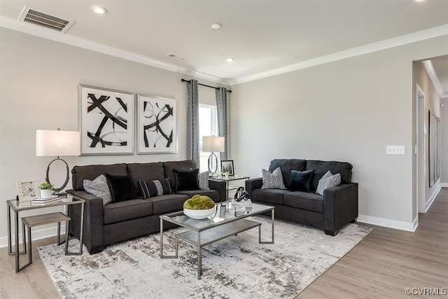 living room featuring light hardwood / wood-style floors and crown molding