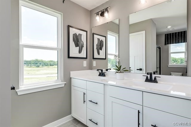 bathroom featuring tile patterned floors, vanity, and toilet