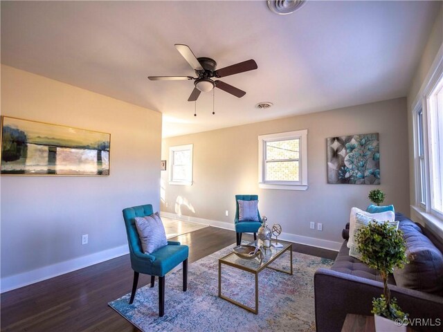 living area with dark hardwood / wood-style floors and ceiling fan