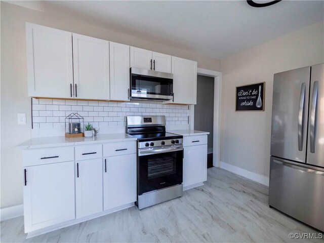 kitchen featuring backsplash, white cabinets, and appliances with stainless steel finishes