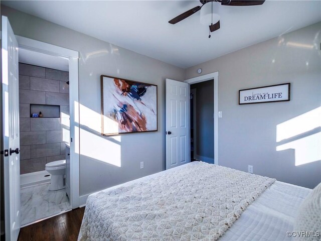 bedroom featuring ceiling fan, ensuite bathroom, and dark wood-type flooring