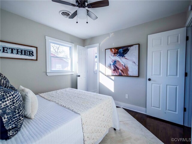 bedroom featuring ceiling fan and dark hardwood / wood-style flooring