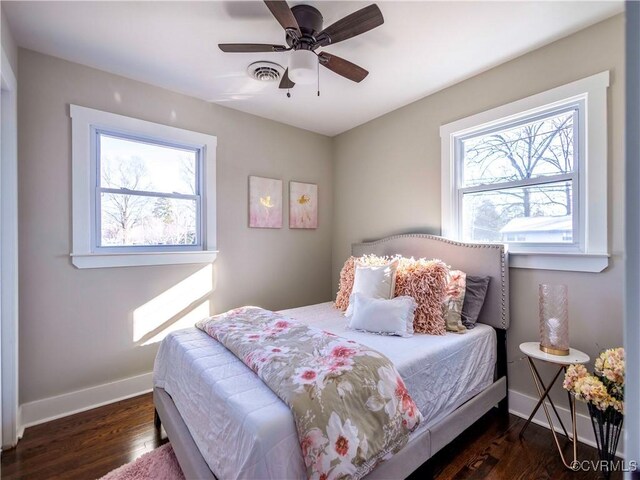 bedroom with ceiling fan and dark hardwood / wood-style floors