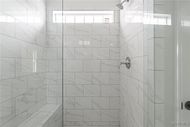 bathroom with a tile shower