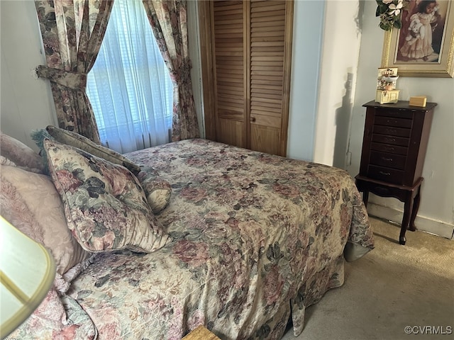 bedroom featuring a closet and light colored carpet