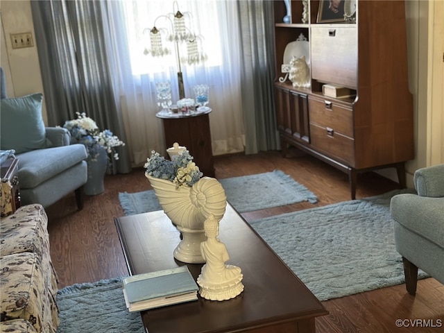 living room featuring a chandelier and dark hardwood / wood-style floors