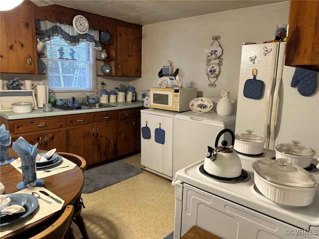 kitchen with white appliances and sink