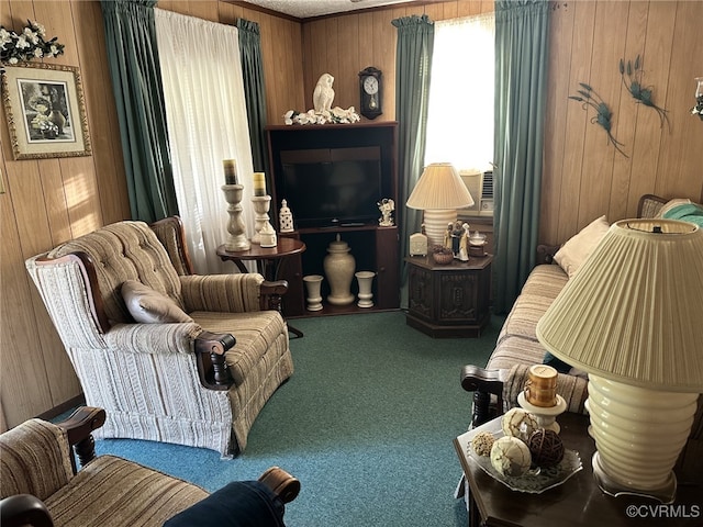 living area with carpet flooring, wood walls, and crown molding