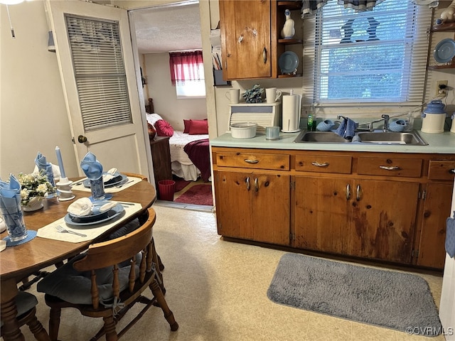 kitchen featuring a textured ceiling and sink