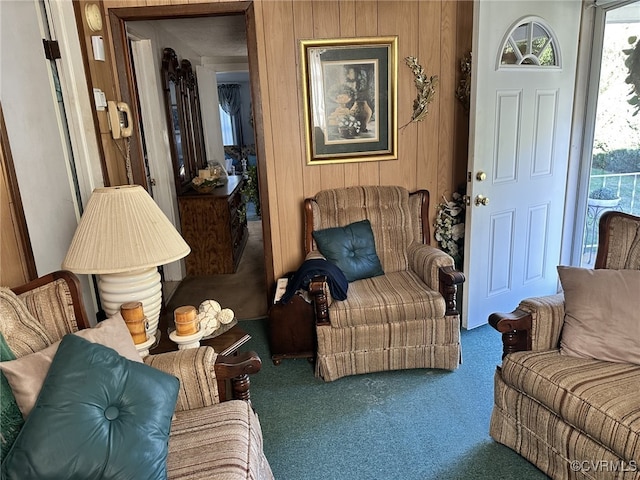 living room with carpet flooring and wood walls