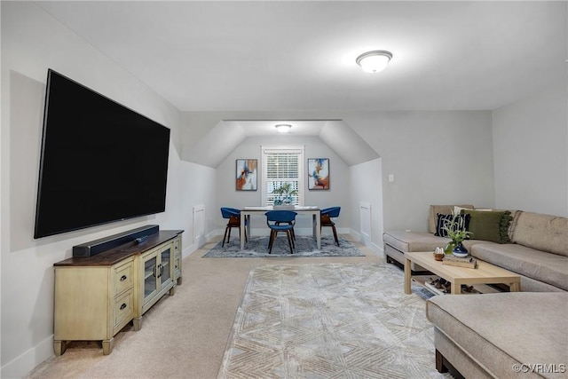 living room featuring light colored carpet and lofted ceiling