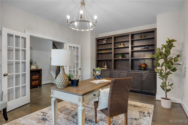 office featuring built in shelves, french doors, dark wood-type flooring, and an inviting chandelier