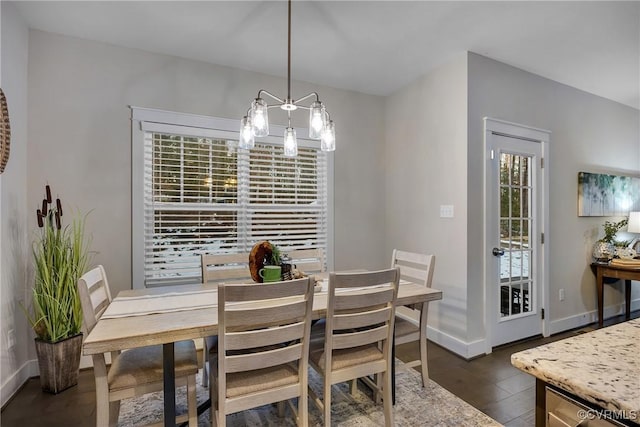 dining space featuring a notable chandelier and dark hardwood / wood-style flooring