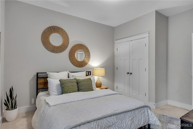 bedroom with light colored carpet and a closet