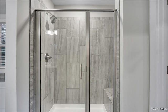 bathroom with a shower with shower door