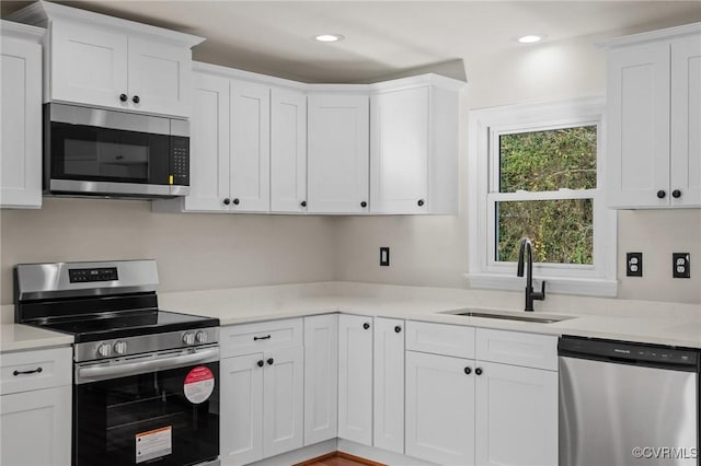 kitchen with white cabinets, sink, and stainless steel appliances