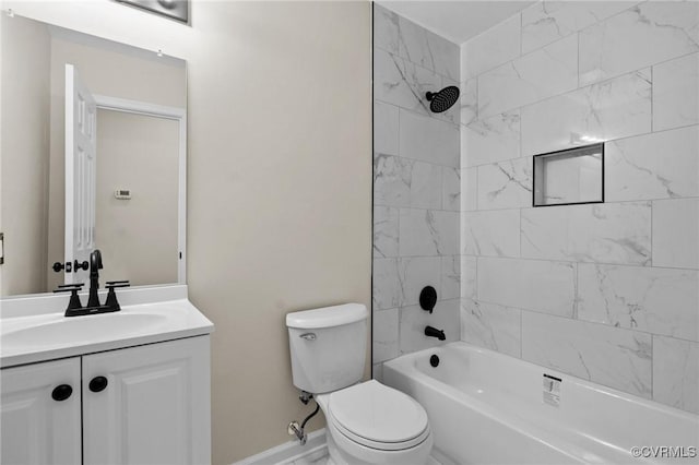 full bathroom with vanity, tiled shower / bath combo, and toilet