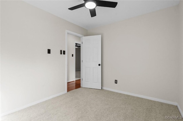 unfurnished room with ceiling fan and light carpet