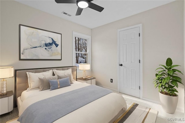 bedroom with ceiling fan and light carpet