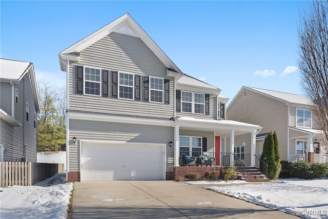 view of front property with a porch and a garage