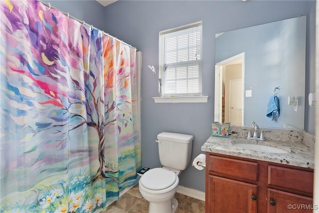 bathroom featuring curtained shower, tile patterned flooring, toilet, vanity, and baseboards