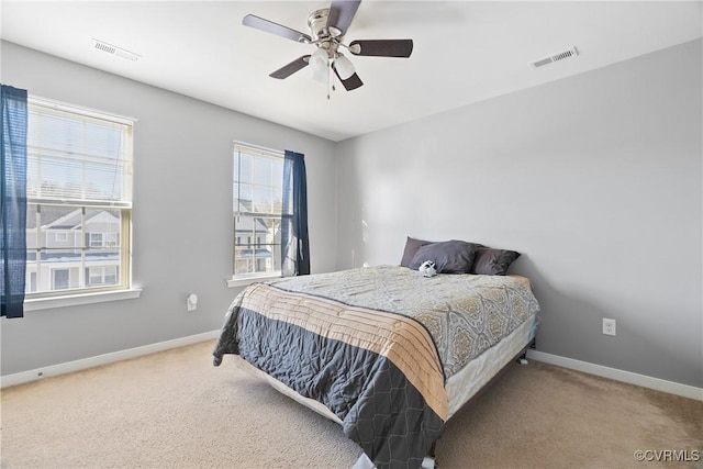 bedroom featuring multiple windows, carpet floors, and ceiling fan