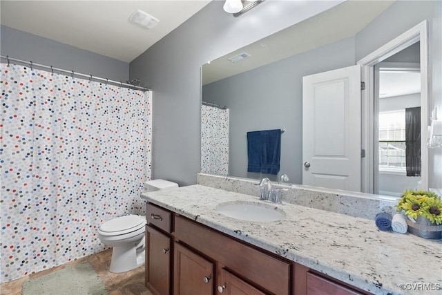 bathroom featuring toilet, a shower with shower curtain, vanity, and visible vents